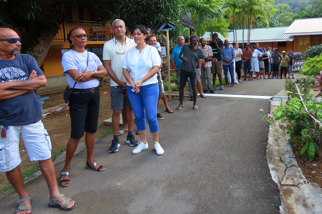 People line up to cast their votes at Beau Vallon Secondary School in Beau Vallon, Seychelles, on Saturday, Sep. 27, 2025. (AP Photo/Emilie Chetty)