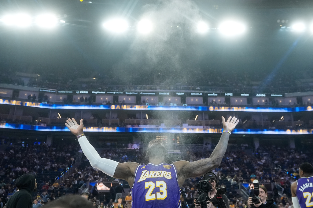 FILE - Los Angeles Lakers forward LeBron James throws chalk in the air before an NBA basketball game against the Golden State Warriors in San Francisco, April 9, 2026. (AP Photo/Jeff Chiu, File)