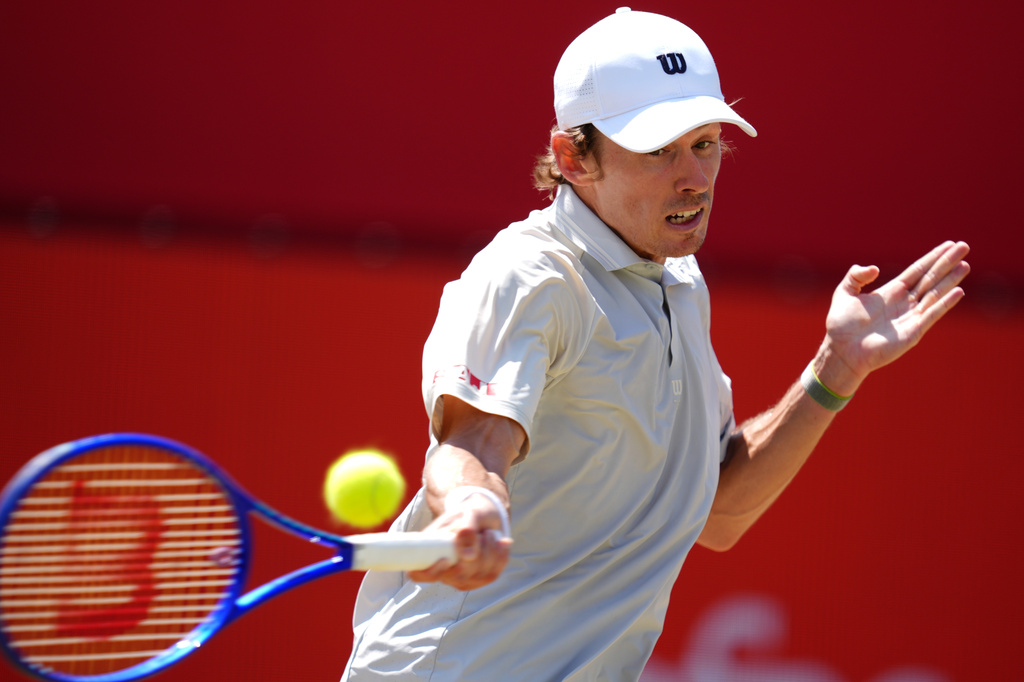 Alex De Minaur of Australia in action against Brandon Nakashima of the US in the men's singles quarterfinal match on day twelve of the Tennis Championships at The Queen's Club, in London, Friday, June 19, 2026. (Adam Davy/PA via AP)