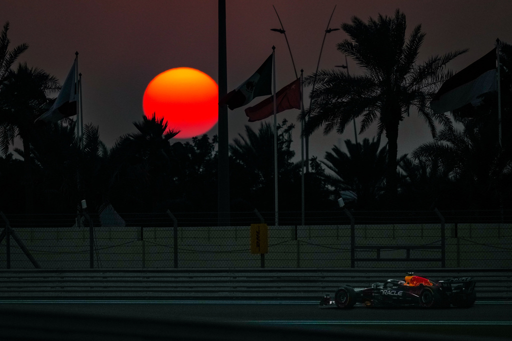 Red Bull driver Max Verstappen of the Netherlands steers his car during the Formula One Abu Dhabi Grand Prix at Yas Marina Circuit in Abu Dhabi, United Arab Emirates, Sunday, Dec. 7, 2025, as the sun sets behind the track. (AP Photo/Altaf Qadri)