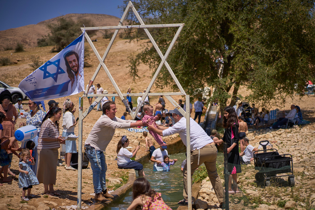 Israeli settlers and others enjoy a day at a spring in the Jordan Valley during Israel's Independence Day, in Auja, in the occupied West Bank, Wednesday, April 22, 2026. (AP Photo/Ohad Zwigenberg)