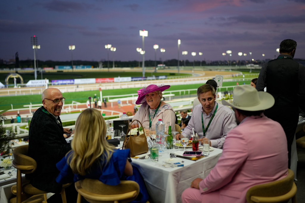 Racegoers dine in the grandstand during the Dubai World Cup at Meydan Racecourse in Dubai, United Arab Emirates, Saturday, March 28, 2026. (AP Photo/Altaf Qadri)