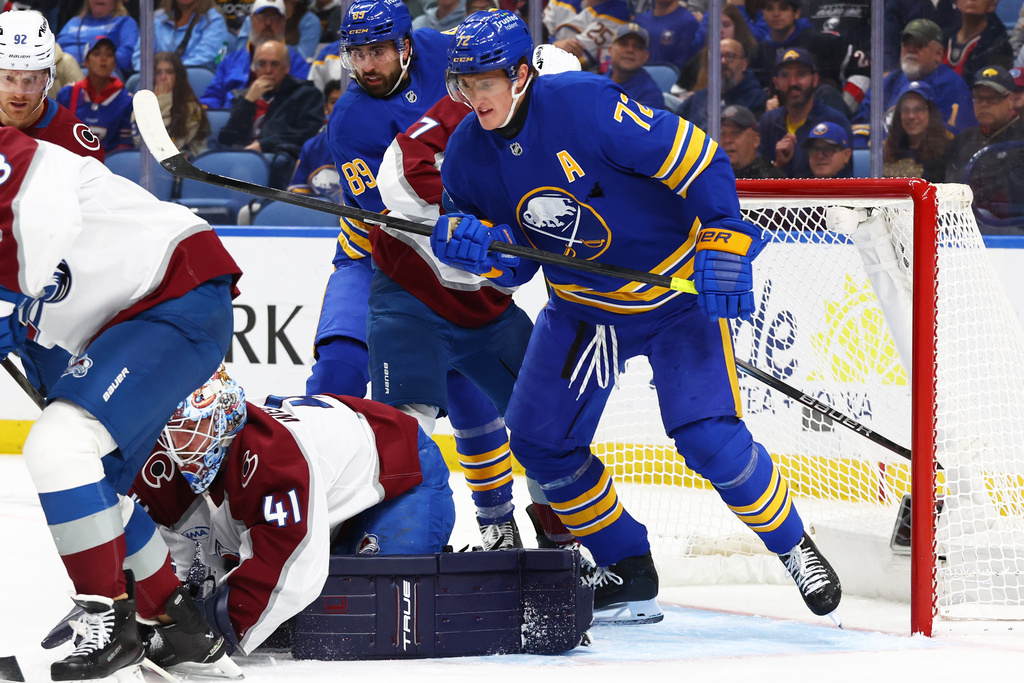 Colorado Avalanche goaltender Scott Wedgewood (41) covers the puck in front of Buffalo Sabres center Tage Thompson (72) during the first period of an NHL hockey game Monday, Oct. 13, 2025, in Buffalo, N.Y. (AP Photo/Jeffrey T. Barnes)