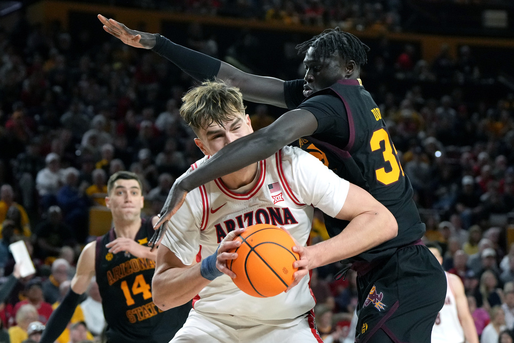 Arizona State center Massamba Diop (35) fouls Arizona center Motiejus Krivas during the first half of an NCAA college basketball game, Saturday, Jan. 31, 2026, in Tempe, Ariz. (AP Photo/Rick Scuteri)