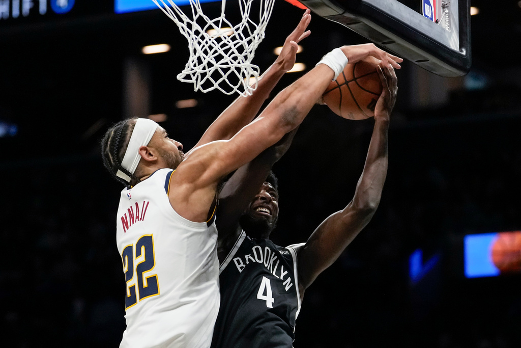 Denver Nuggets forward Zeke Nnaji (22) blocks Brooklyn Nets guard Drake Powell (4) during the first half of an NBA basketball game, Sunday, Jan. 4, 2026, in New York. (AP Photo/Yuki Iwamura)