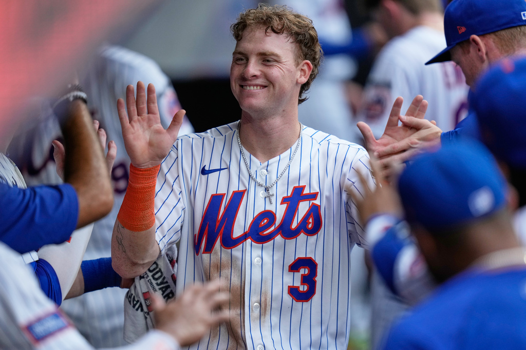 New York Mets' Carson Benge celebrates in the dugout after scoring on a Francisco Alvarez single during the fifth inning of a baseball game against the Kansas City Royals, Thursday, July 9, 2026, in New York. (AP Photo/Seth Wenig)