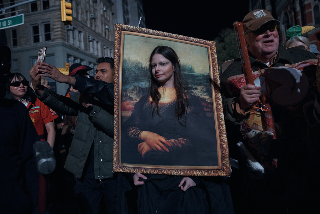 A reveler pauses for a photograph during the Village Halloween Parade on Friday, Oct. 31, 2025, in New York. (AP Photo/Andres Kudacki)