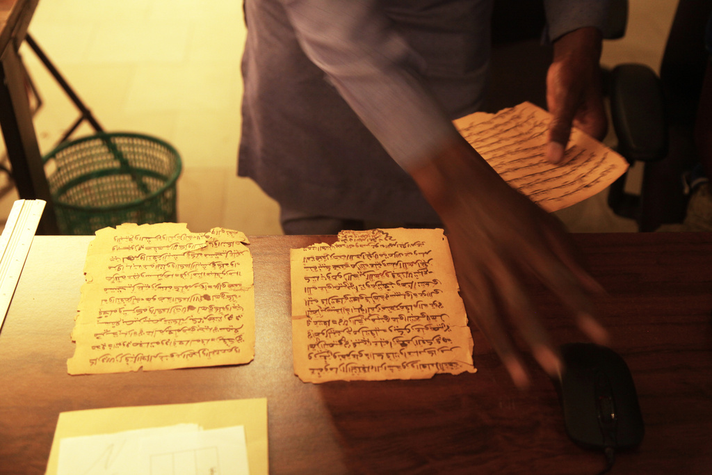 Manuscript pages are being scan at the Ahmed Baba Institute of Higher Islamic Studies and Research in Timbuktu, Mali, Sept. 4, 2025. (AP Photo/Baba Ahmed)