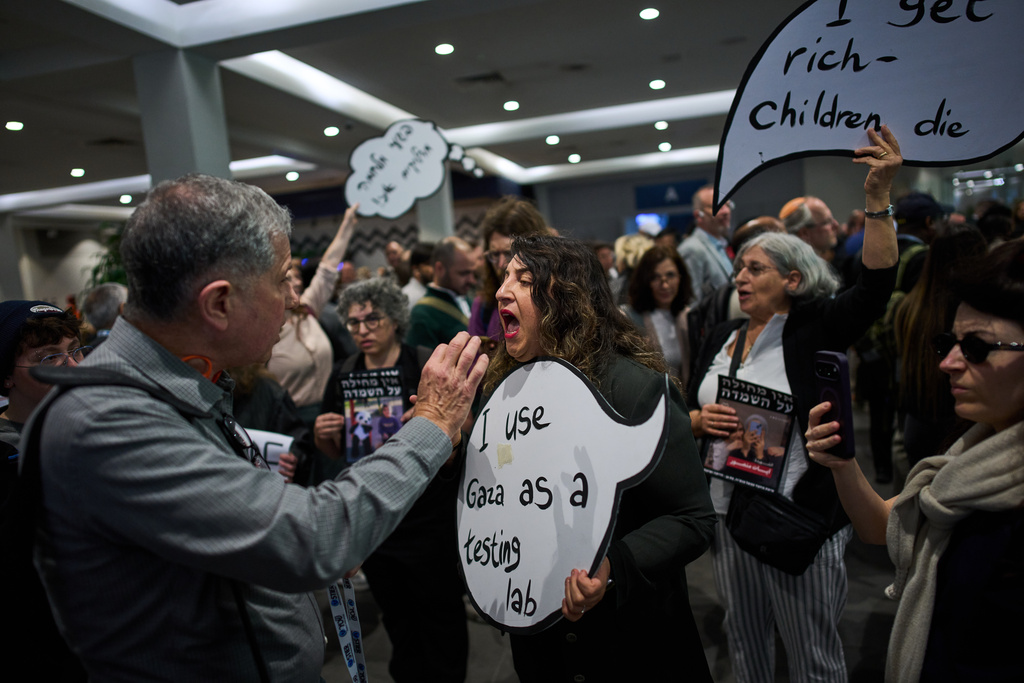 Activists protest against a defense industry exhibition in Tel Aviv, Israel, Tuesday, Feb. 17, 2026. (AP Photo/Oded Balilty)