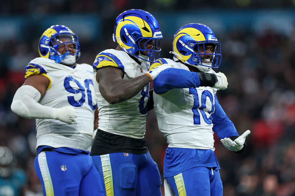 Los Angeles Rams Josaiah Stewart (10), linebacker Jared Verse (8) and defensive end Tyler Davis (90) react after a sack on Jacksonville Jaguars quarterback Trevor Lawrence (16) during the second half of an NFL football game between the Los Angeles Rams and the Jacksonville Jaguars in London, Sunday, Oct. 19, 2025. (AP Photo/Ian Walton)