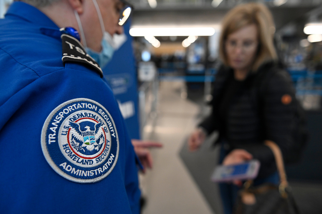 A TSA agent checks a passenger's ticket and boarding pass at Ohare Airport in Chicago, Thursday, March 26, 2026. (AP Photo/Paul Beaty)