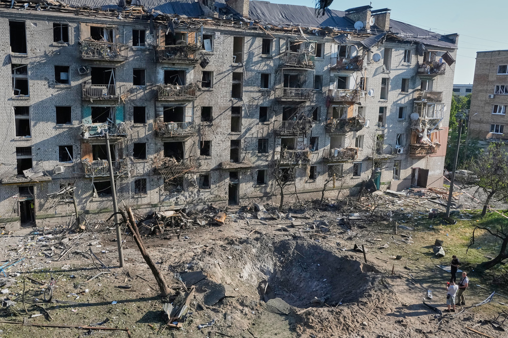 People look at the site of a Russian missile strike that hit a residential building in Kyiv, Ukraine, Thursday, July 2, 2026. (AP Photo/Efrem Lukatsky)