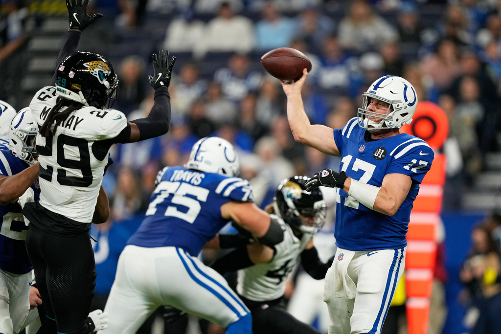 Indianapolis Colts quarterback Philip Rivers (17) throws under pressure from Jacksonville Jaguars safety Eric Murray (29) during the second half of an NFL football game Sunday, Dec. 28, 2025, in Indianapolis. (AP Photo/Carolyn Kaster)