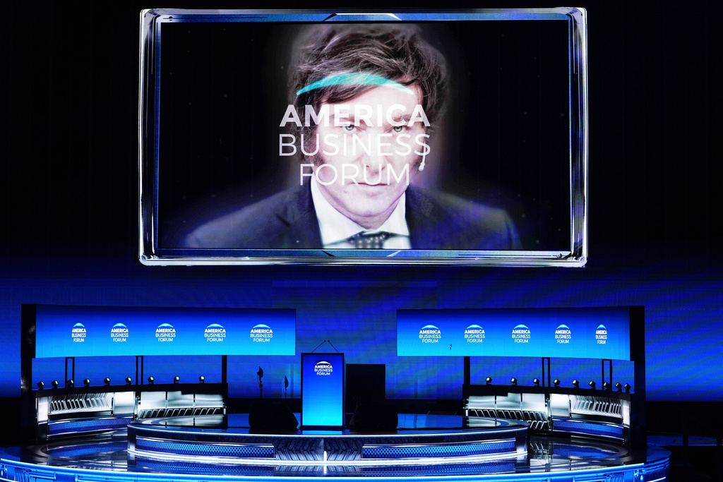 FILE - An image of Argentina's President Javier Milei appears on a large screen at the America Business Forum, Nov. 6, 2025 in Miami. (AP Photo/Rebecca Blackwell, File)