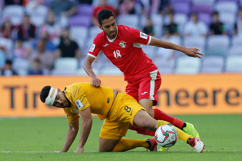 FILE - Jordan's midfielder Musa Al-Taamari, top, battles for a ball with Australia's midfielder Massimo Luongo during the AFC Asian Cup group B soccer match between Australia and Jordan at Hazza bin Zayed stadium in Al Ain, United Arab Emirates, Sunday, Jan. 6, 2019. (AP Photo/Hassan Ammar, File)