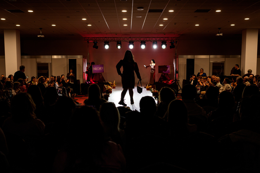 A young woman walks on the podium during the SEEN Anonymous Seamstresses Gala, an event organised by the Down Plus Bucharest, an NGO supporting youngsters with Down Syndrome and other intellectual disabilities, in Bucharest, Romania, Wednesday, March 18, 2026, ahead of the World Down Syndrome Day, on March 21. (AP Photo/ Vadim Ghirda)