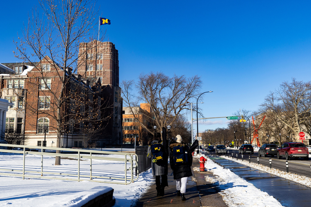 Students walk around the University of Michigan campus in Ann Arbor, Mich., Jan. 17, 2026. (AP Photo/Emily Elconin)