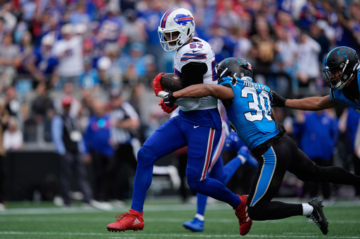 Buffalo Bills defensive end AJ Epenesa (57) is tackled by Carolina Panthers running back Chuba Hubbard (30) after Epenesa made an interception during the first half an NFL football game, Sunday, Oct. 26, 2025, in Charlotte, N.C. (AP Photo/Erik Verduzco) Buffalo Bills defensive end AJ Epenesa (57) is tackled by Carolina Panthers running back Chuba Hubbard (30) after Epenesa made an interception during the first half an NFL football game, Sunday, Oct. 26, 2025, in Charlotte, N.C. (AP Photo/Erik Verduzco)
