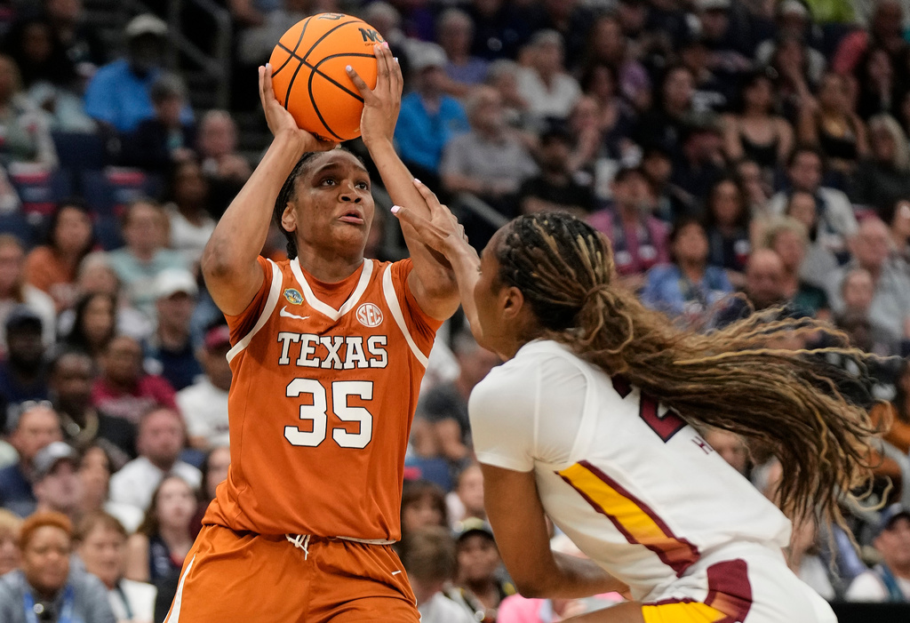 FILE - Texas forward Madison Booker (35) is fouled while shooting by South Carolina guard Bree Hall (23) during the first half of a national semifinal Final Four game during the women's NCAA college basketball tournament, on April 4, 2025, in Tampa, Fla. (AP Photo/Chris O'Meara, File)