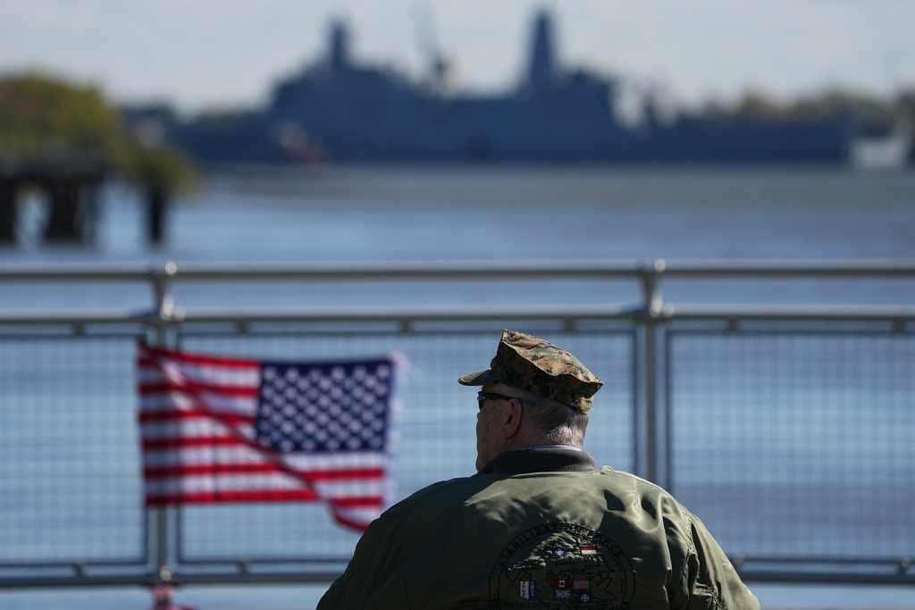John Robertson, Navy and Marine Corps veteran, watch the U.S. Navy ships pass the viewing stand during the 250th anniversary of the founding of the U.S. Navy and Marine Corps, along the Delaware River, Thursday, Oct. 9, 2025, in Philadelphia. (AP Photo/Matt Rourke)