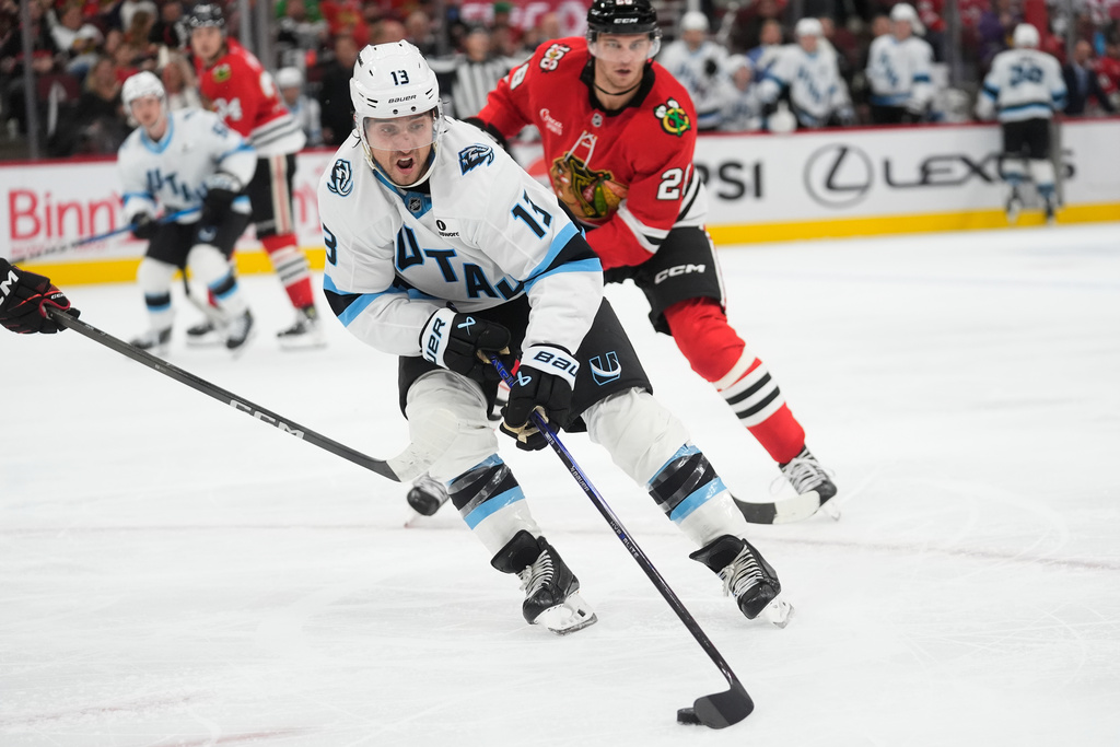 Utah Mammoth left wing Brandon Tanev (13) handles the puck during the second period of an NHL hockey game against the Chicago Blackhawks, Monday, Oct. 13, 2025, in Chicago. (AP Photo/Erin Hooley)