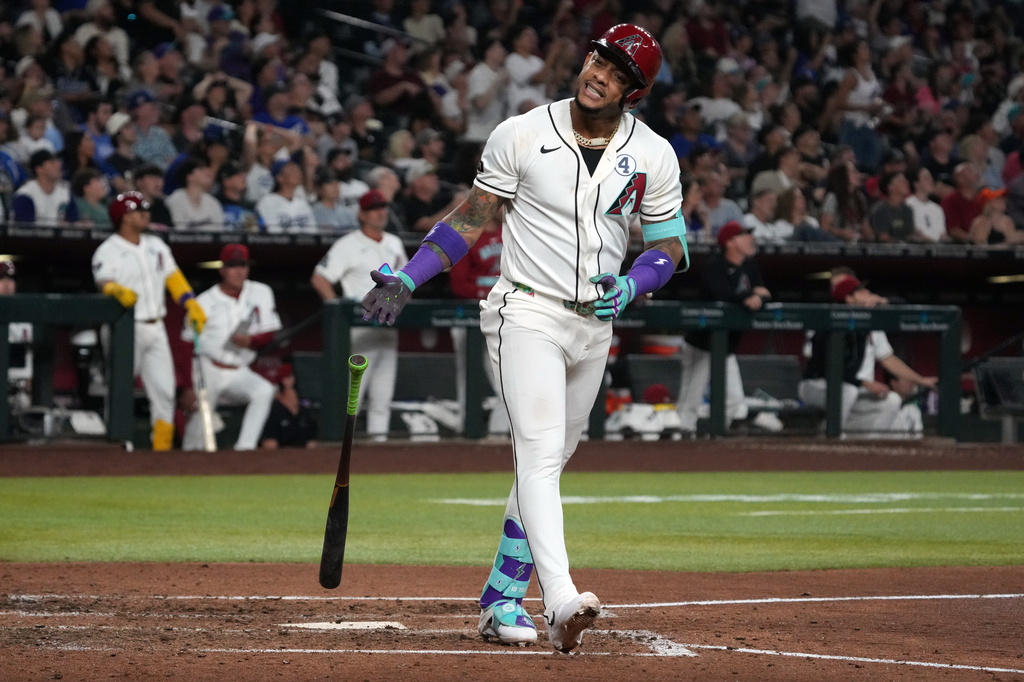 Arizona Diamondbacks' Ketel Marte reacts after hitting a sacrifice RBI fly out against the Los Angeles Dodgers in the fifth inning of a baseball game, Tuesday, June 2, 2026, in Phoenix. (AP Photo/Rick Scuteri)
