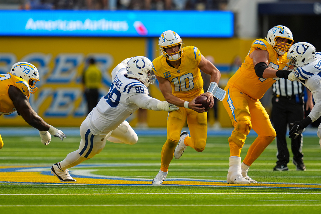 Indianapolis Colts defensive tackle Deforest Buckner (99) pressures Los Angeles Chargers quarterback Justin Herbert (10) during the second half of an NFL football game Sunday, Oct. 19, 2025, in Inglewood, Calif. (AP Photo/Gregory Bull)