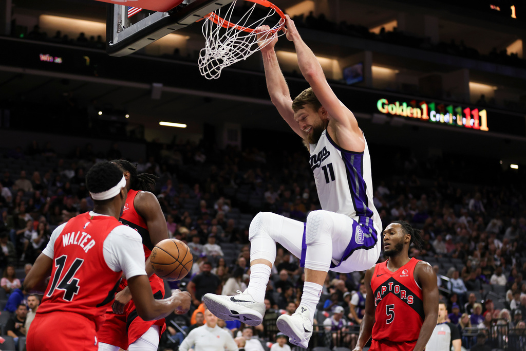 Sacramento Kings forward Domantas Sabonis (11) dunks the ball during the first half of an NBA basketball preseason game against the Toronto Raptors, Wednesday, Oct. 8, 2025, in Sacramento, Calif. (AP Photo/Scott Marshall)