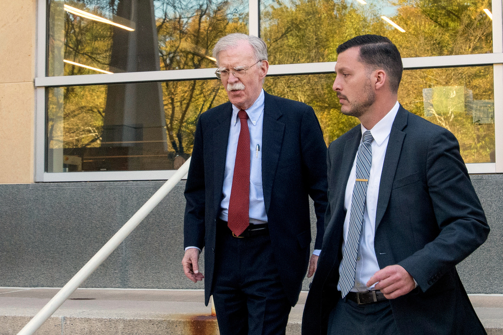 Former Trump administration national security adviser John Bolton, left, departs following his arraignment at the federal courthouse in Greenbelt, Md., Friday, Oct. 17, 2025. (AP Photo/Rod Lamkey, Jr.)