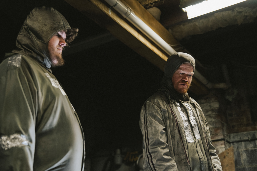 This image released by Focus Features shows Aidan Delbis, left, and Jesse Plemons in a scene from "Bugonia." (Atsushi Nishijima/Focus Features via AP)