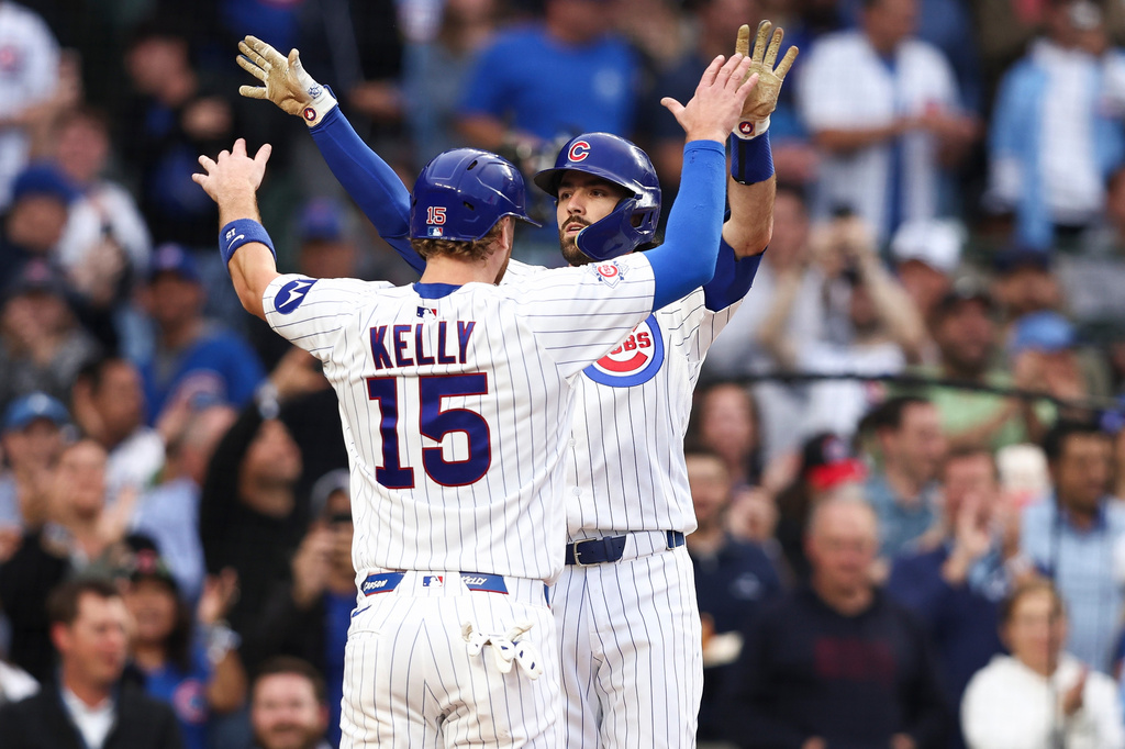 Chicago Cubs' Dansby Swanson, back, celebrates with catcher Carson Kelly (15) during the second inning of a baseball game against the Colorado Rockies in Chicago, Wednesday, June 17, 2026. (AP Photo/Jessie Alcheh)