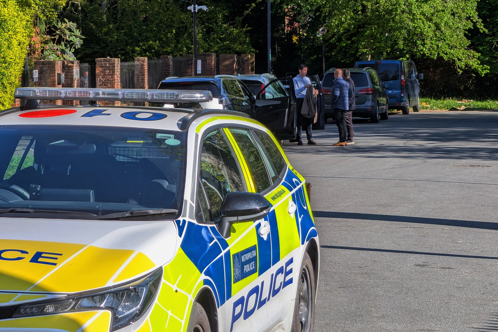Police officers patrol at a cordon near Kenton United Synagogue in Harrow, a suburb of London, Sunday, April 19, 2026. (Jamie Lashmar/PA via AP)