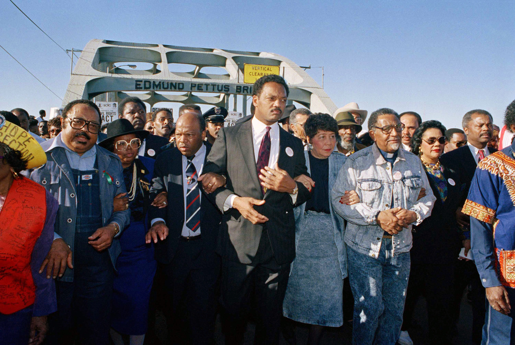 FILE - Civil rights figures lead marchers across the Edmund Pettus Bridge during the recreation of the 1965 Selma to Montgomery march in Selma, Ala., on March 4, 1990. From left are Hosea Williams, Georgia Congressman John Lewis, Rev. Jesse Jackson, Evelyn Lowery, SCLC President Joseph Lowery and Coretta Scott King. (AP Photo/Jamie Sturtevant, File)