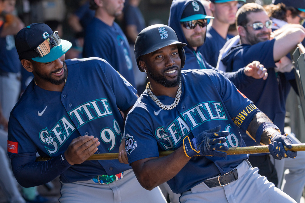 Seattle Mariners' Randy Arozarena, right, jokes with Lazaro Montes (99) after hitting a home run during the eighth inning of a baseball game against the Athletics, Sunday, Sept. 13, 2026, in West Sacramento, Calif. (AP Photo/Sara Nevis)