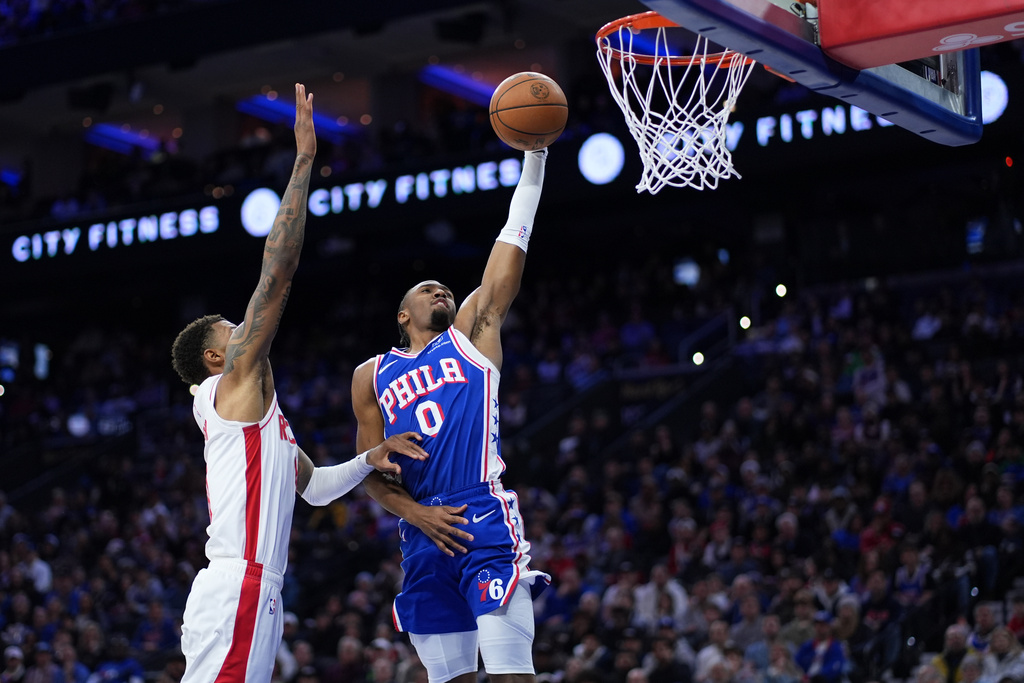 Philadelphia 76ers' Tyrese Maxey, right, goes up for a dunk against Houston Rockets' Jabari Smith Jr. during the first half of an NBA basketball game Thursday, Jan. 22, 2026, in Philadelphia. (AP Photo/Matt Slocum)