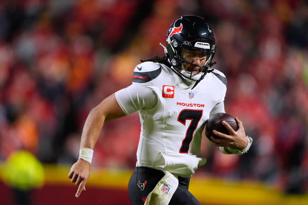 Houston Texans quarterback C.J. Stroud scrambles during the second half of an NFL football game against the Kansas City Chiefs Sunday, Dec. 7, 2025, in Kansas City, Mo. (AP Photo/Charlie Riedel)