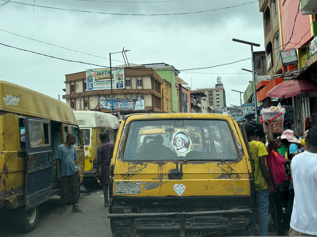 Commercial bus drivers wait for passengers inside a market in Lagos, Nigeria, Tuesday, Aug. 18, 2026. (AP Photo/Sunday Alamba)