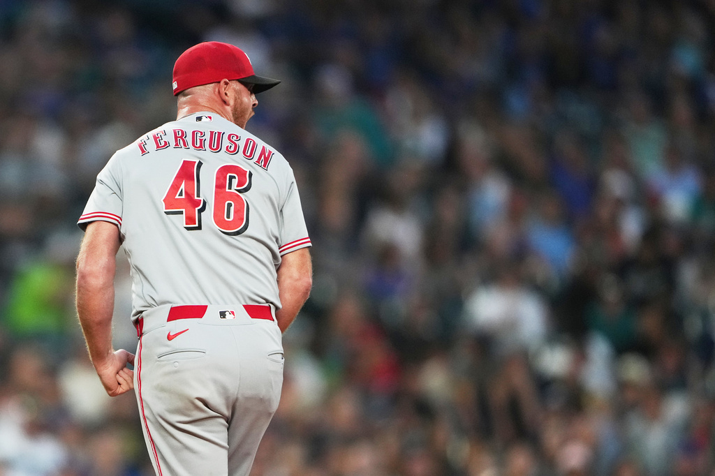 Cincinnati Reds relief pitcher Caleb Ferguson reacts in the seventh inning of a baseball game against the Seattle Mariners, Monday, July 20, 2026, in Seattle. (AP Photo/Lindsey Wasson)