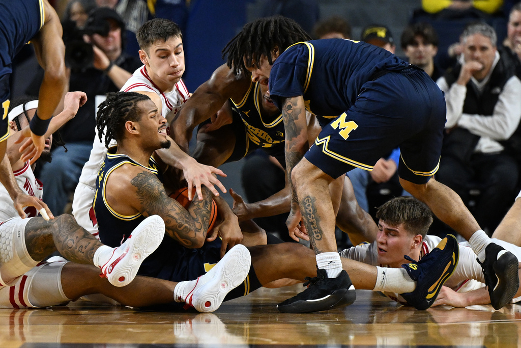 Michigan Wolverines guard Roddy Gayle Jr. (11) tries to call a time out after getting control of a loose ball against the Wisconsin in the first half of an NCAA college basketball game in Ann Arbor, Mich., Saturday, January 10, 2026. (AP Photo/Lon Horwedel)