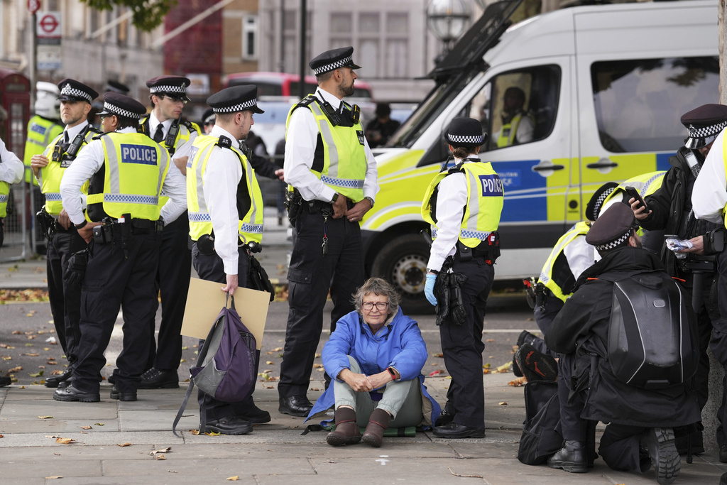 Police remove a protester taking part in a demonstration organised by Defend our Juries, in support of Palestine Action in Trafalgar Square, London Saturday Oct. 4, 2025. (Maja Smiejkowska/PA via AP)