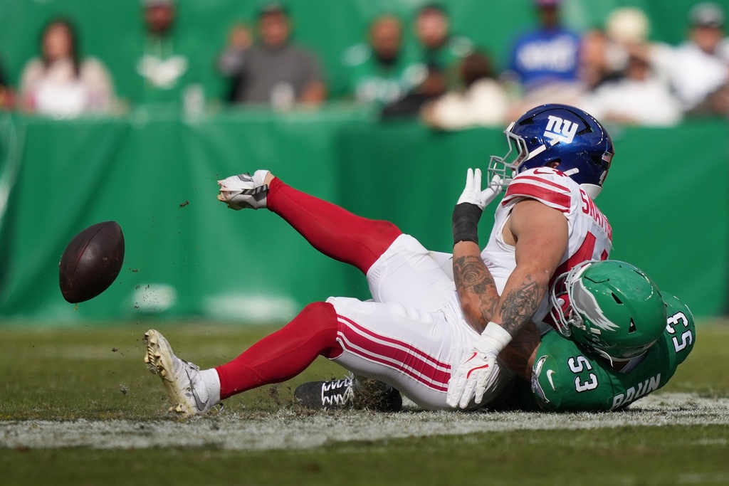 New York Giants running back Cam Skattebo (44) is injured near Philadelphia Eagles linebacker Zack Baun (53) during the first half of an NFL football game Sunday, Oct. 26, 2025, in Philadelphia. (AP Photo/Matt Slocum)