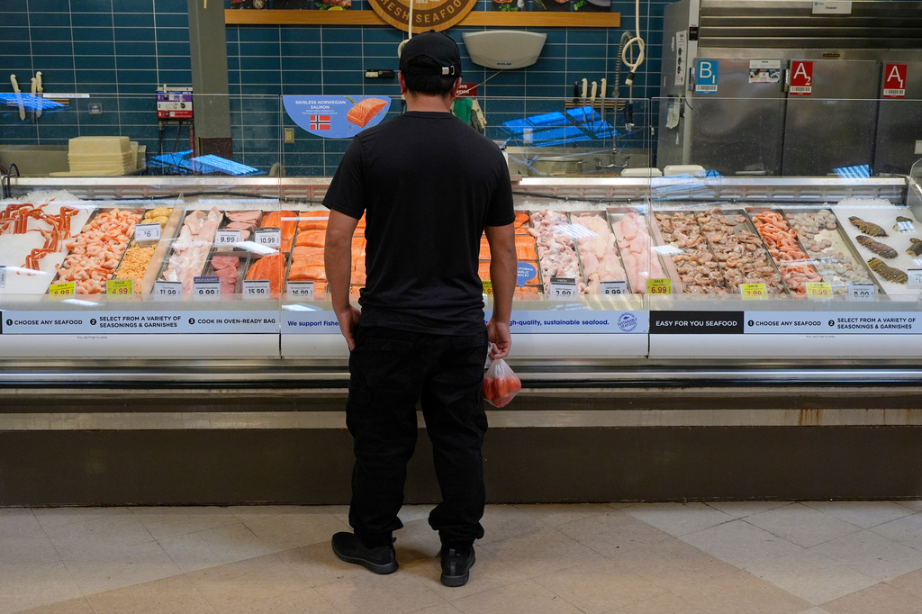 A person looks at the fresh fish at a grocery store Monday, May 11, 2026, in Nashville, Tenn. (AP Photo/George Walker IV)