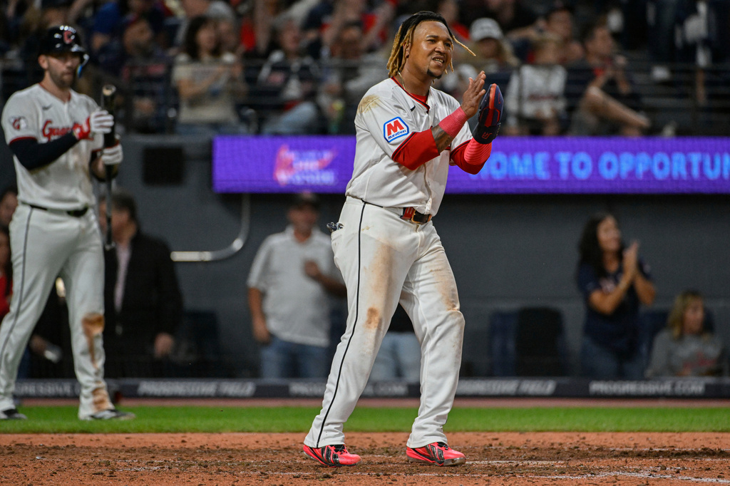 Cleveland Guardians' Jose Ramirez, center, reacts after scoring on a single hit by Angel Martinez during the sixth inning of a baseball game against the Athletics, Saturday, Sept. 19, 2026, in Cleveland. (AP Photo/Phil Long)