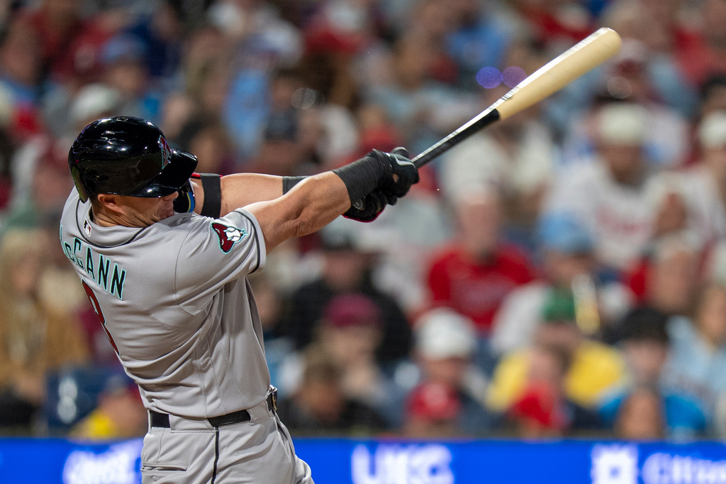 Arizona Diamondbacks' James McCann hits a a two-run double during the fifth inning of a baseball game against the Philadelphia Phillies, Friday, April 10, 2026, in Philadelphia. (AP Photo/Chris Szagola)