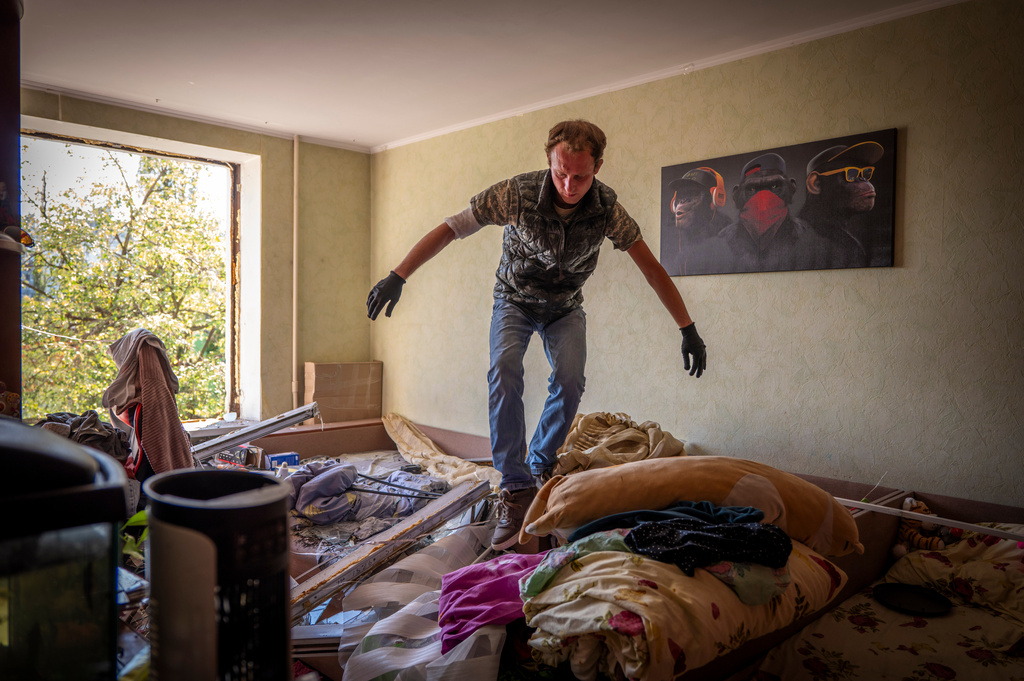 A man inspects damage to his apartment after a Russian missile exploded near his home in Kyiv, Ukraine, Thursday, Sept. 17, 2026. (AP Photo/Dan Bashakov)