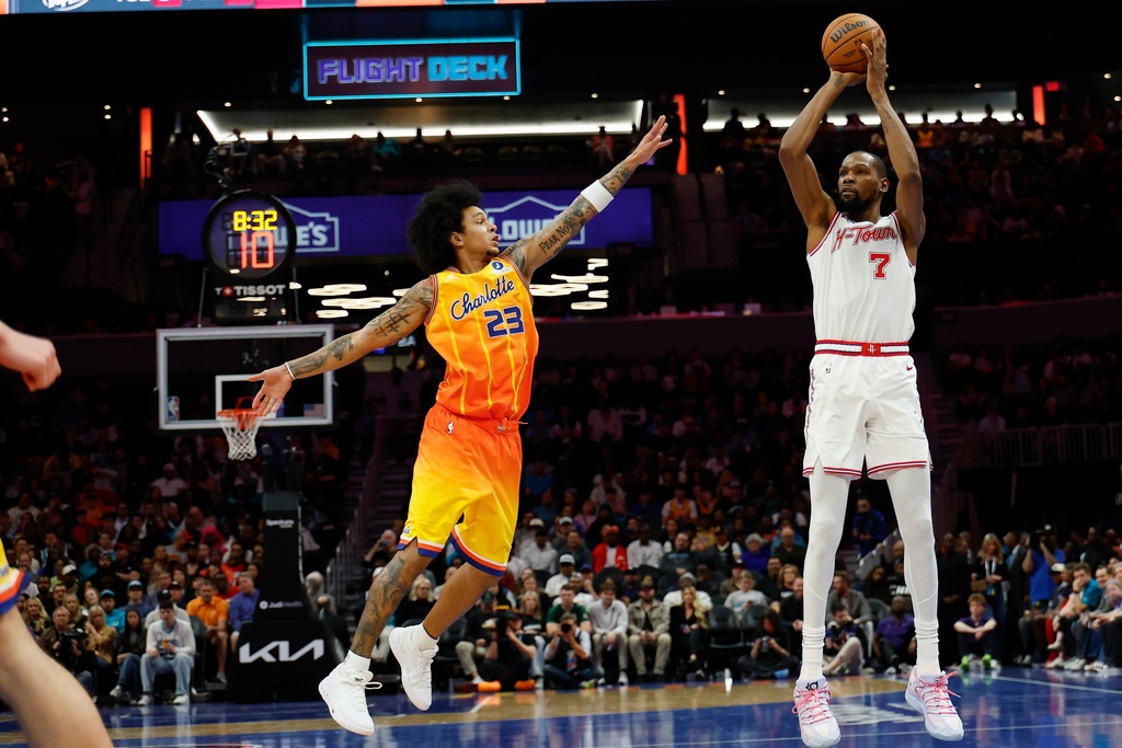 Houston Rockets forward Kevin Durant (7) shoots against Charlotte Hornets guard Tre Mann during the first half of an NBA basketball game in Charlotte, N.C., Thursday, Feb. 19, 2026. (AP Photo/Nell Redmond)