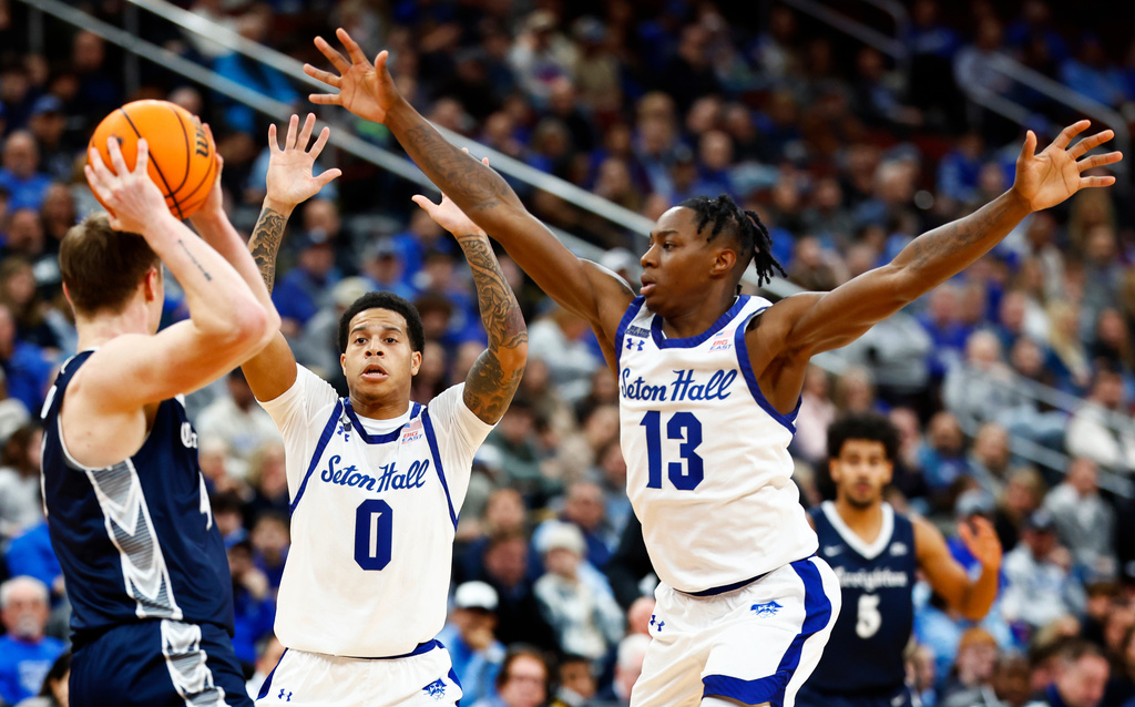 Seton Hall guards Adam Clark (0) and Trey Parker (13), defend against Creighton guard Josh Dix, left, during the second half of an NCAA college basketball game, Sunday, Jan. 4, 2026, in Newark, N.J. (AP Photo/Noah K. Murray)