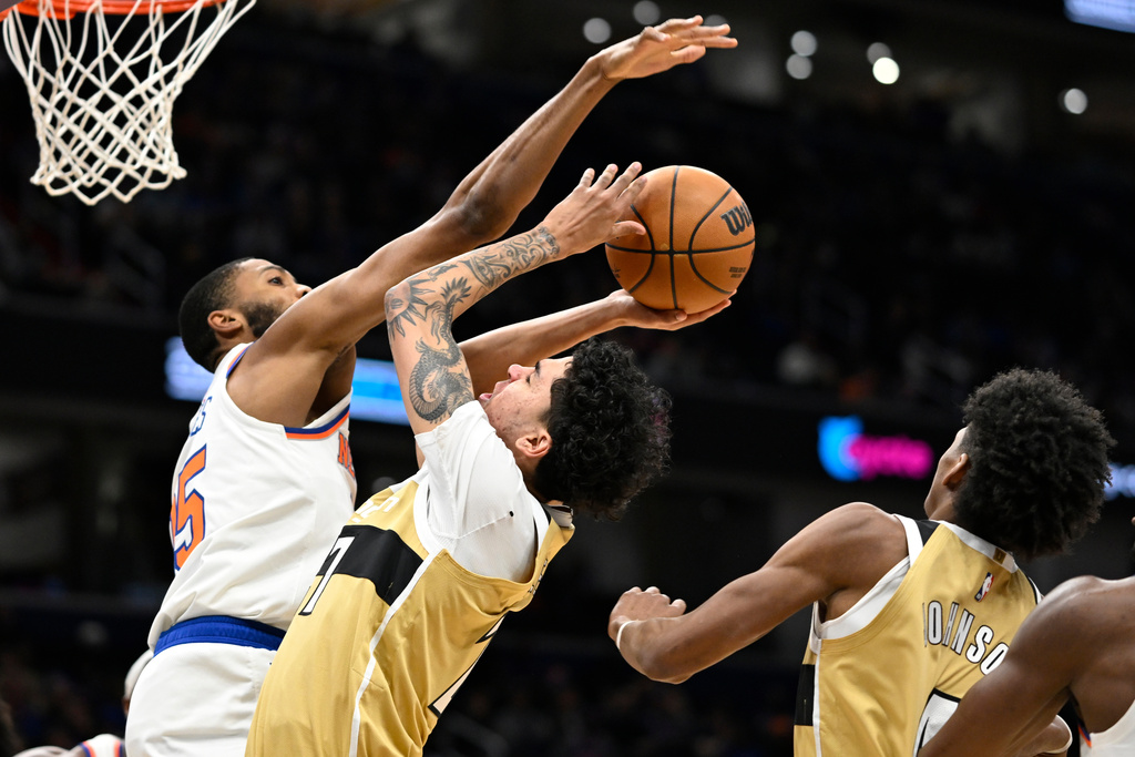 Washington Wizards guard Will Riley goes to shoot against New York Knicks guard Mikal Bridges during the first half of an NBA basketball game, Tuesday, Feb. 3, 2026, in Washington. (AP Photo/John McDonnell)