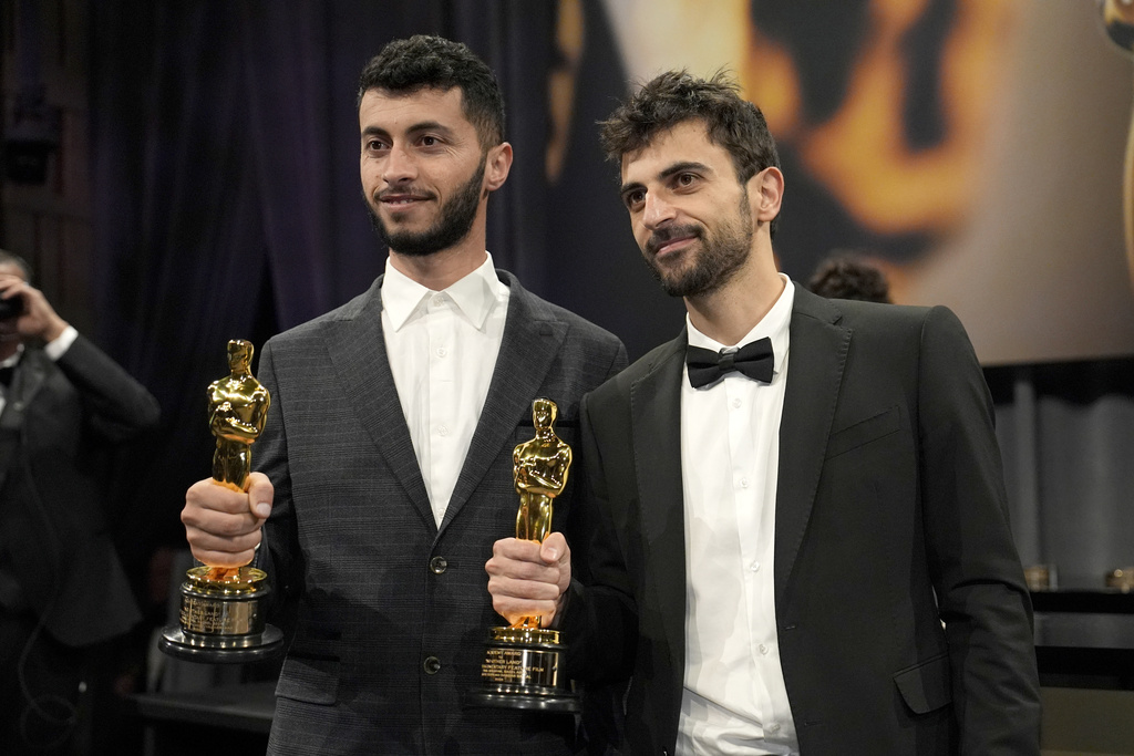 FILE - Basel Adra, left, and Yuval Abraham, winners of the Oscar for best documentary feature film for "No Other Land," pose for photos at the Governors Ball, in Los Angeles, March 2, 2025. (AP Photo/John Locher, File)
