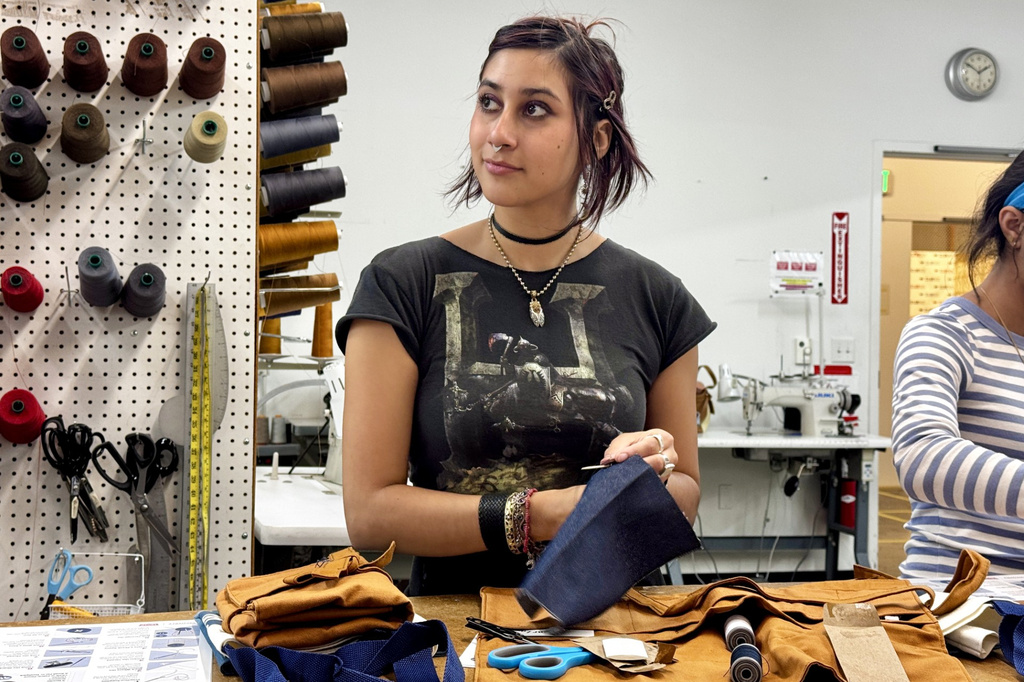 Ava Trujillo practices attends a clothing repair workshop at a Levi's retail store in downtown San Francisco, Wednesday, July 22, 2026. (AP Photo/Terry Chea)
